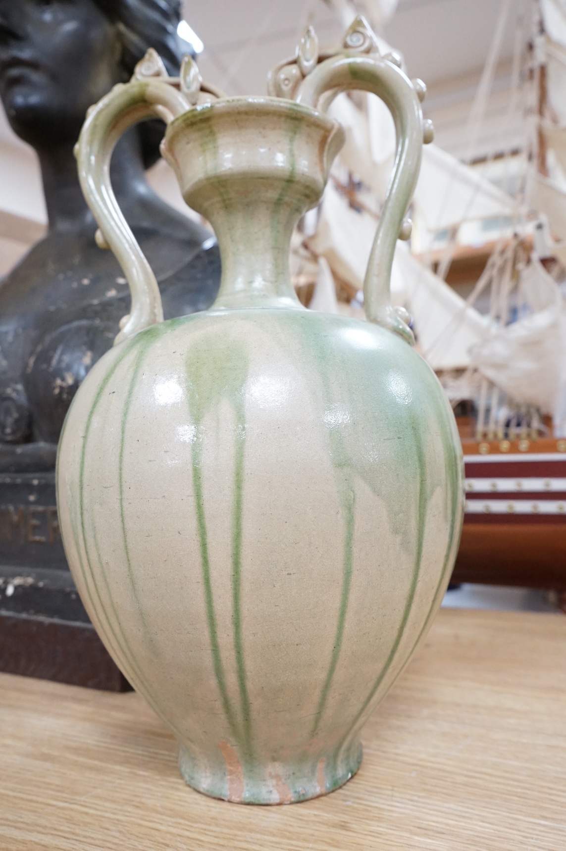 A Chinese green glazed terracotta ‘dragon’ handle vase, 42cm